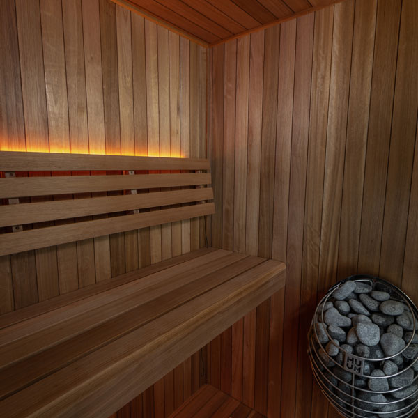 LeisureCraft CT Element Loft Indoor Sauna interior with heater and stones
