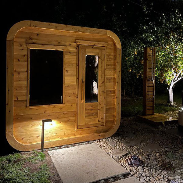 LeisureCraft CT Luna Sauna at dusk with the interior lit