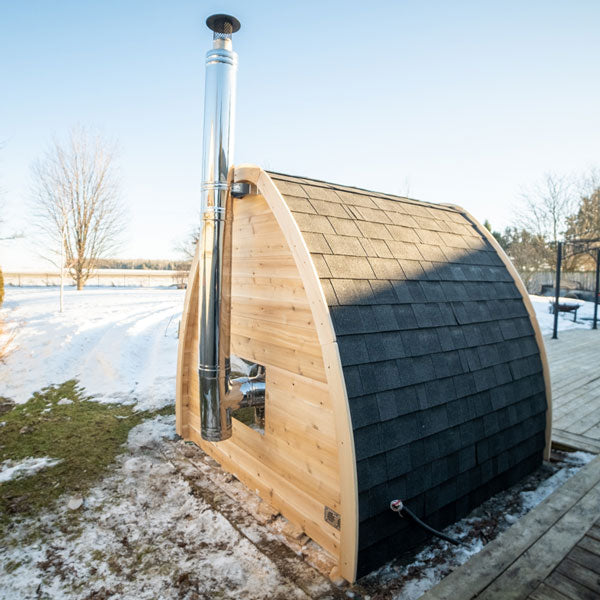 LeisureCraft CT MiniPOD Sauna with wood-burning chimney by the water