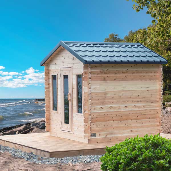 LeisureCraft CT Cabin Sauna on a lakeside shoreline
